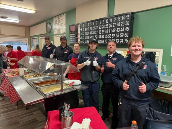 Auxiliary members hosting a Spaghetti dinner to raise funds.